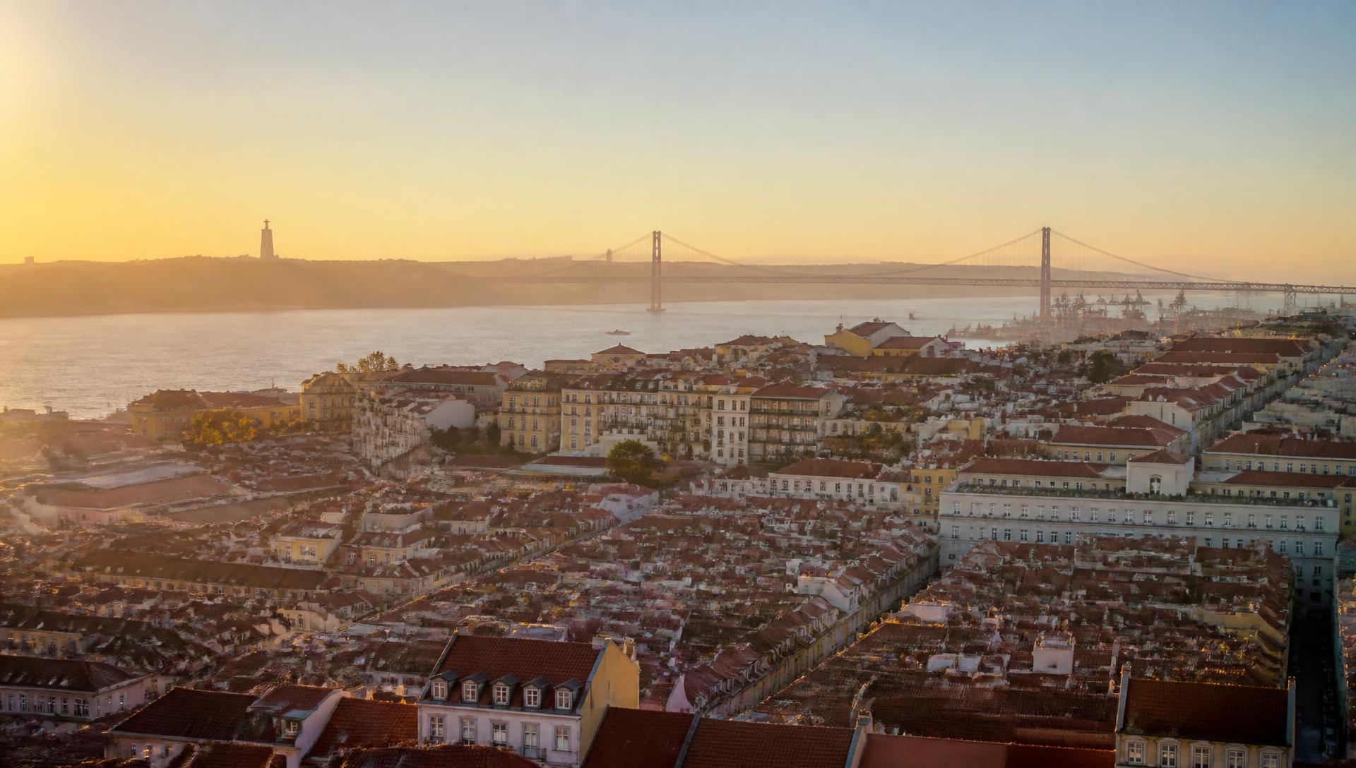 Lisbon rooftops and the Tagus river at golden hour